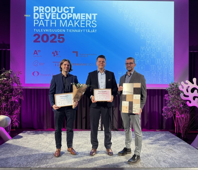 Voittajia palkintojen kanssa lavalla.