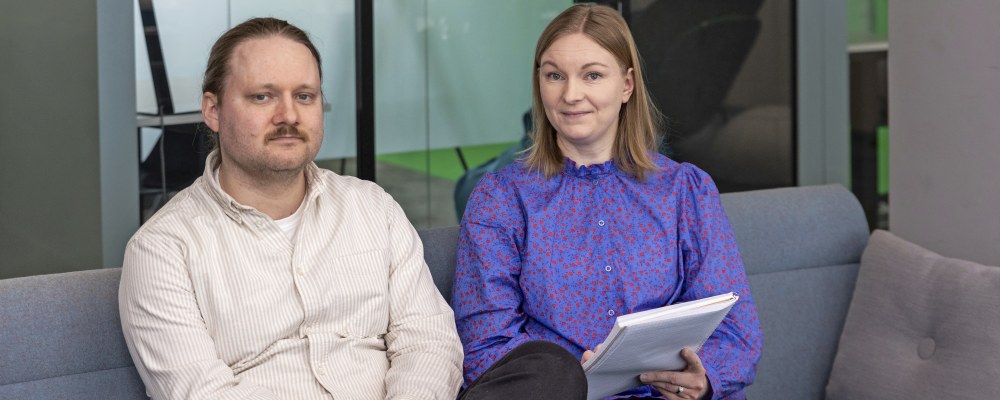 Markus Lindholm ja Minna Vallinrinne istuvat sohvalla.