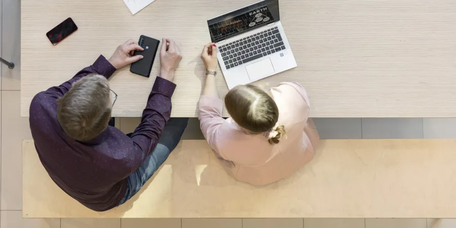 People of different genders working at the same table
